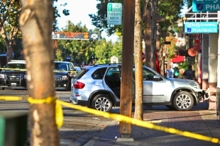 Collision scene: In October a 90-year-old driver struck three boys walking on the sidewalk in Menlo Park, California. Now the driver claims the boys were behaving "recklessly." Image: ##http://www.paloaltoonline.com/news/2013/12/31/driver-responds-to-lawsuit-over-menlo-park-crash-that-injured-6-year-old-twins## Palo Alto Online##