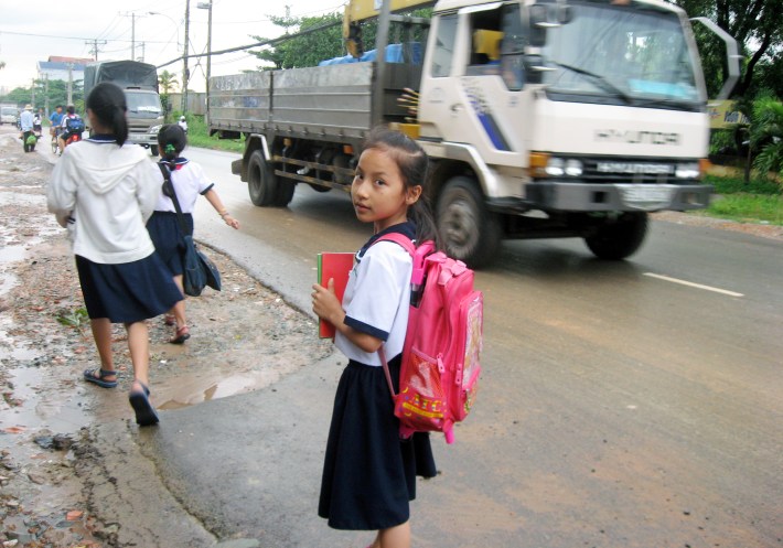"Please give us a safe route to school." This picture of a 9-year-old girl in Vietnam helped catalyze street improvements. All photos courtesy of Safe Streets Worldwide