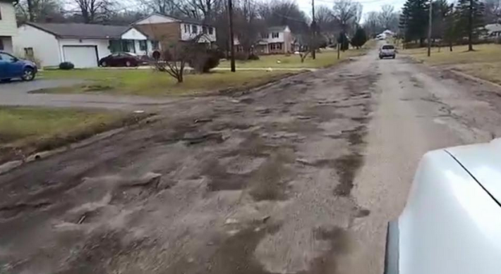 A potholed street in Boardman, Ohio, a middle-class suburb of Youngstown. The Youngstown area has a Facebook group with 800 members devoted to mocking these potholes. Photo: Potholes of Youngstown and Surrounding Areas