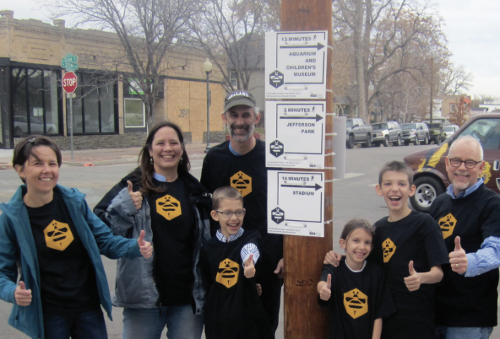 A community group in Denver, Colorado raised money to post walking directions signs advising riders of nearby destinations that are a sort distance by foot. Photo: ioby