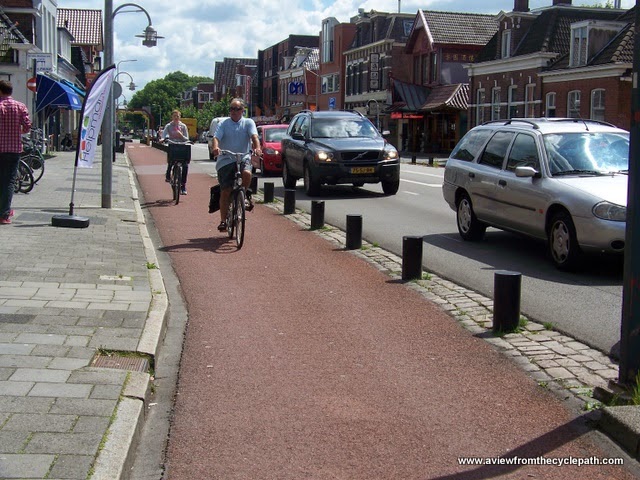 Using concrete to separate the bike lane is awesome! Too bad it's also ugly – and so costly that cities are often loathe to do it. Source: Creative Commons.