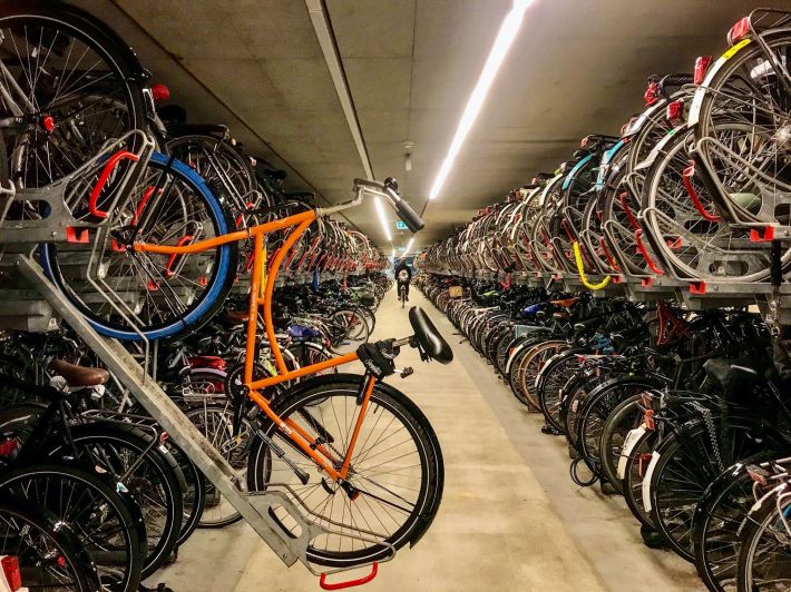 This bike garage near a Delft transit station can hold almost 12,000 bikes — but Chris Bruntlett emphasizes that it's better for cities to "start with 12" bike storage slots than to build nothing at all. Image courtesy of Modacity.