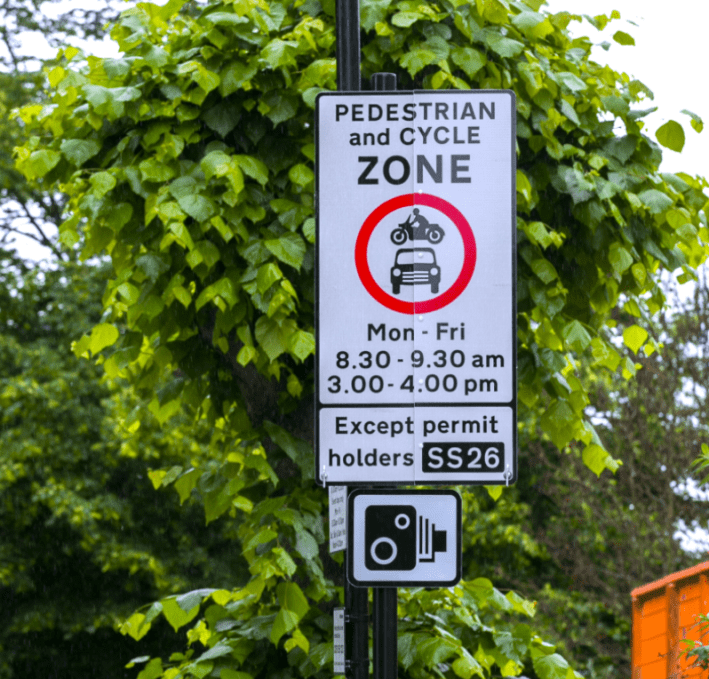 Hackney’s School Street signage: The camera icon indicates the possible presence of automated-traffic enforcement. Photo: Gary Manhine