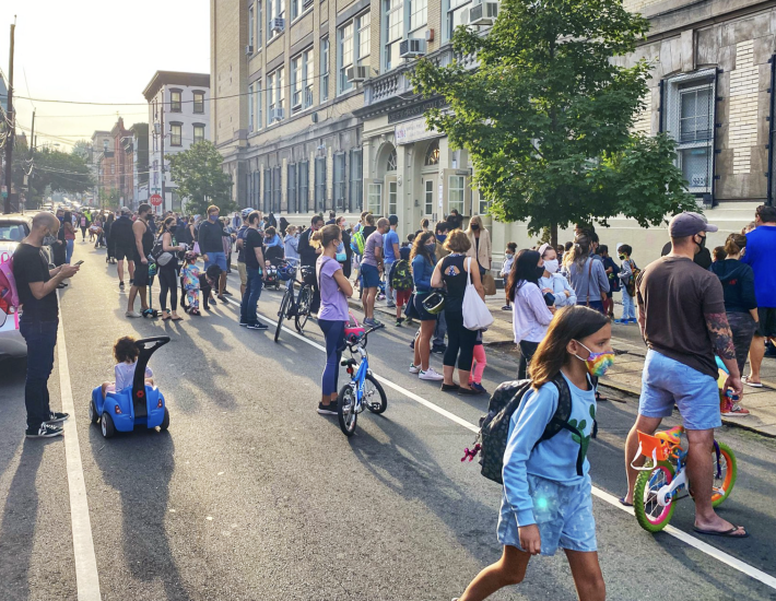 Families use the street to wait for their children to be released from school in Hoboken, N.J. Photo: Juan Melli