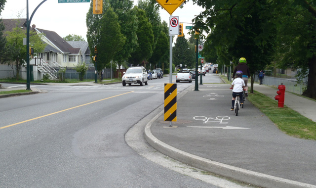 A photo of a bike path on the same level as a sidewalk. Photo: National Association of City Transportation Officials