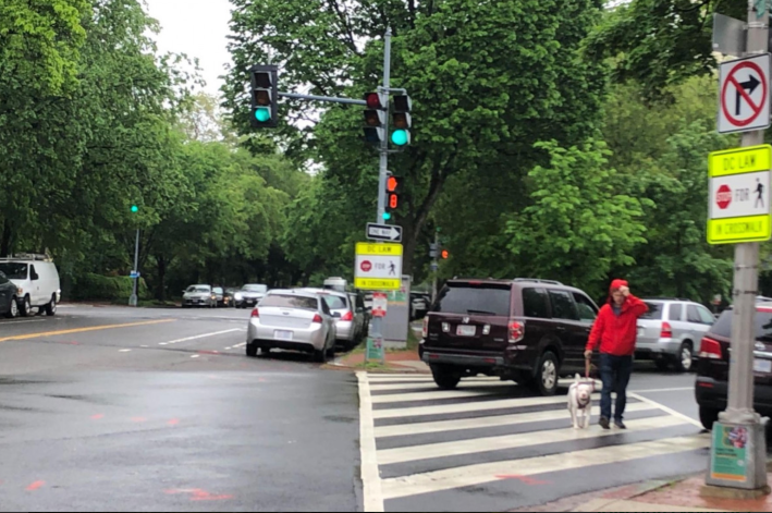 A driver speeds through the intersection of North Carolina Ave and Independence Ave, northeast of Eastern Market, a few feet away from a pedestrian. Photo: Caitlin Rogger