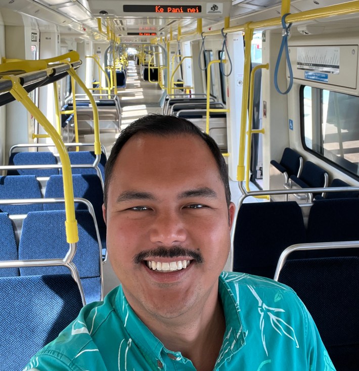 Council Member Tyler Dos Santos-Tam takes a selfie aboard one of the new HART trains to debut in June.