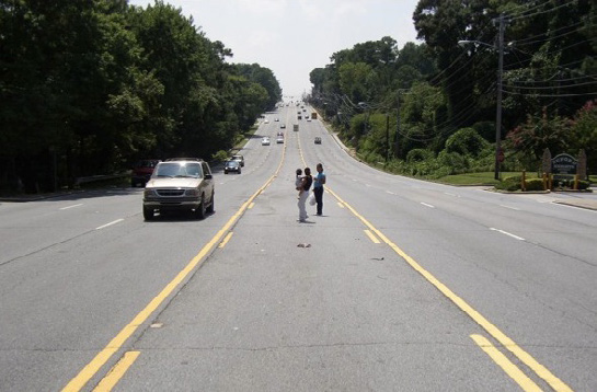 An MUTCD-compliant road that endangers pedestrians by design.